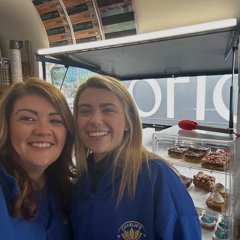 The Charlie's Coffee team smiling during a workplace visit