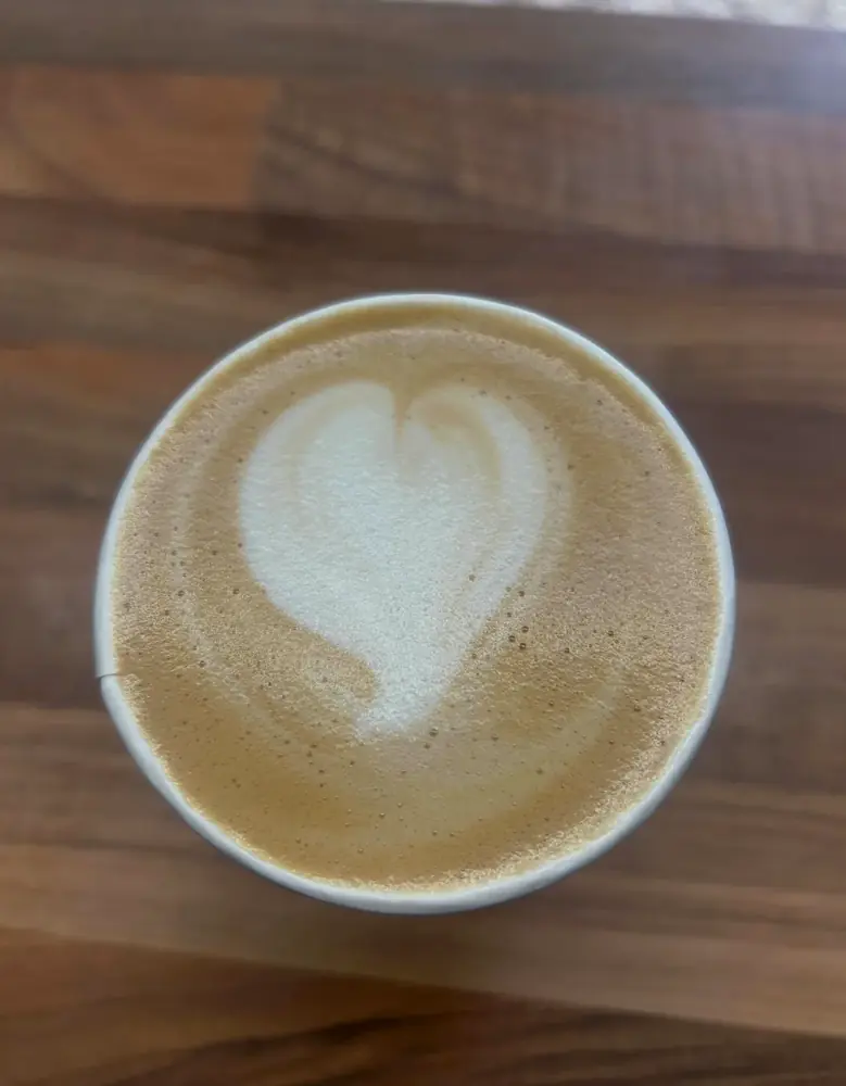 Fresh coffee finished with a heart-shaped latte art design